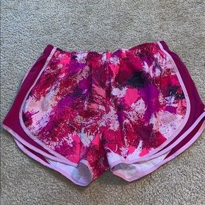 Pink splattered Nike running shorts